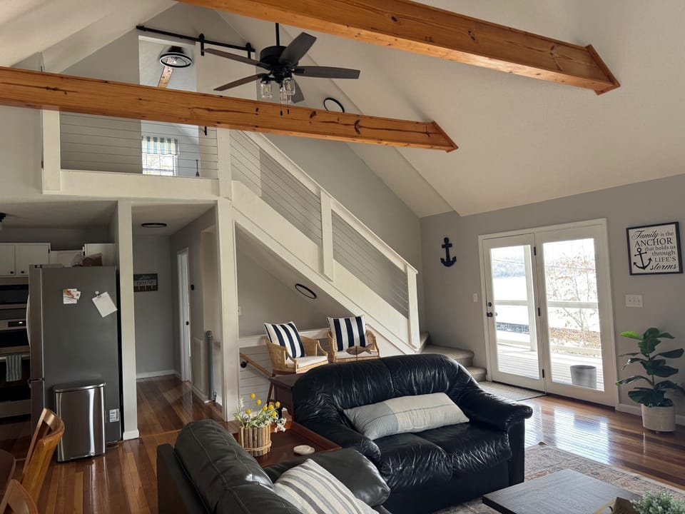 Main level living room with lake views. Walk out to the upper level deck.
