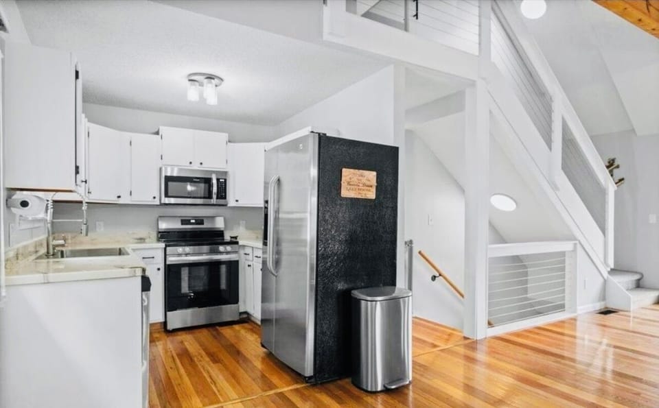 Fully stocked kitchen with open concept to living area.