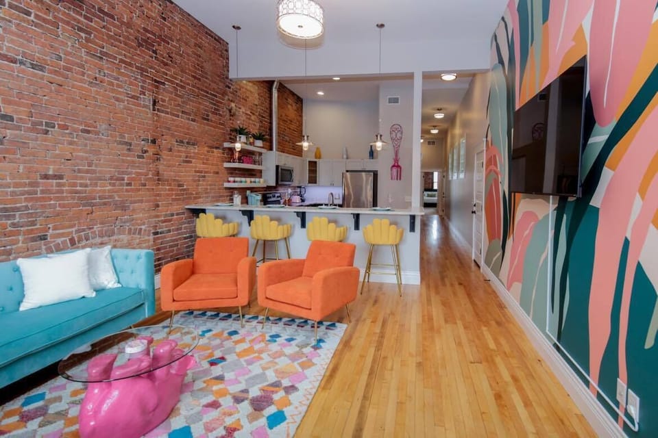 Fun, vibrant living room looking into our fully stocked kitchen.