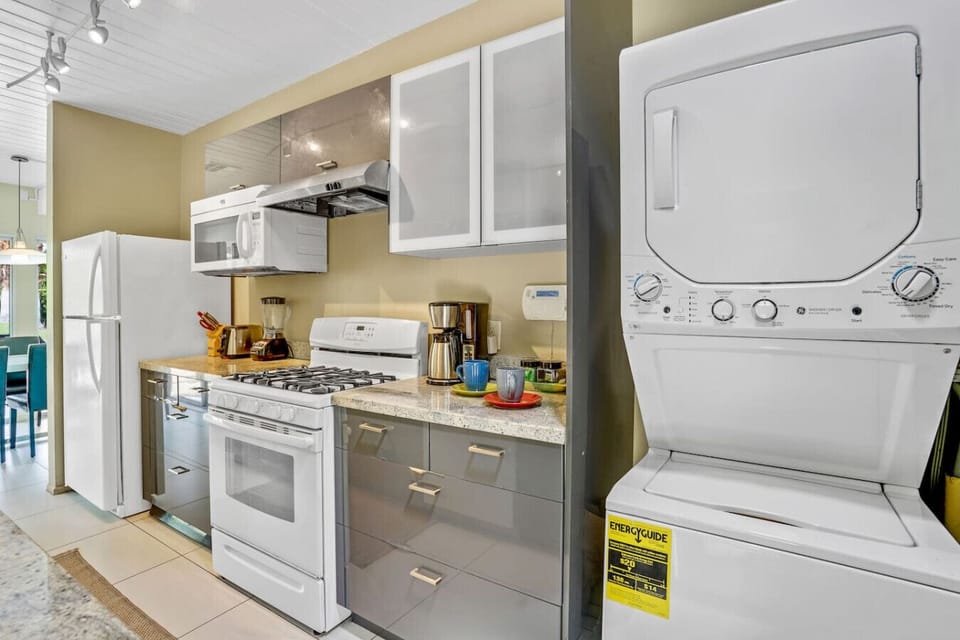 Fully stocked kitchen with modern appliances.