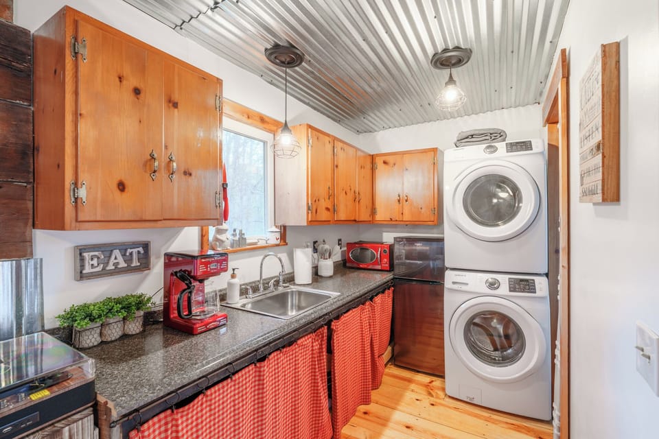 Kitchen has plenty of cabinet and counter space for a tiny cabin. 