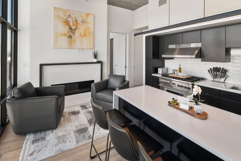 Beautifully designed living area. 65`TV, Gas Fireplace, Spacious Comfy Leather Couch with views of the Delta Center/The Jazz Arena off the deck.