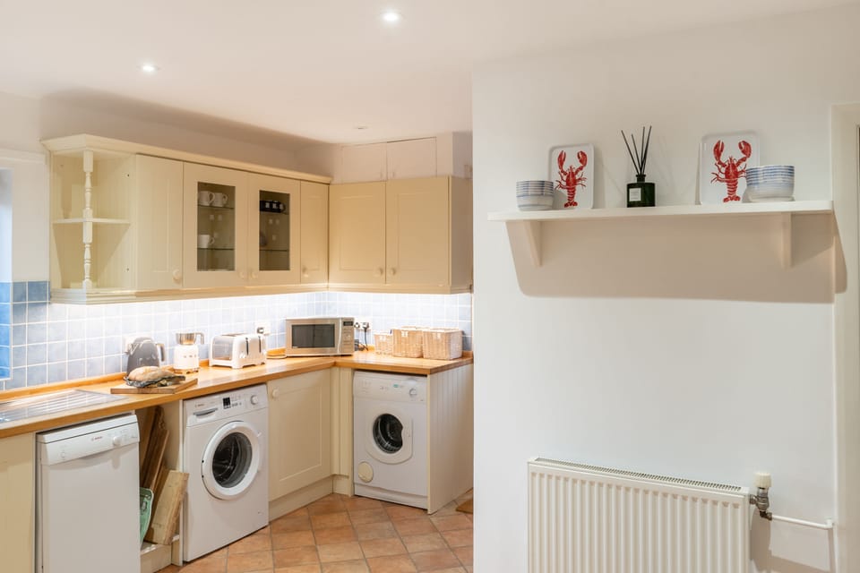 Ground floor: Kitchen with built-in oven, dishwasher, toaster, kettle, and washing machine