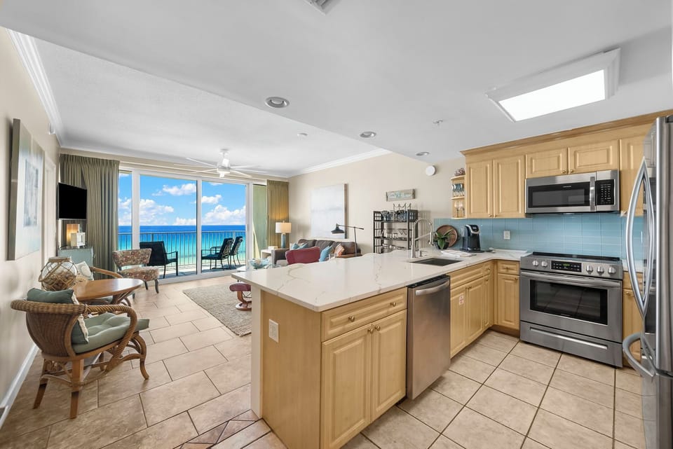 The fully equipped kitchen features quartz countertops, stainless-steel appliances, and has everything you need to prepare meals for family & friends.