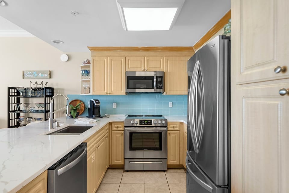 The fully equipped kitchen features quartz countertops, stainless-steel appliances, and has everything you need to prepare meals for family & friends.
