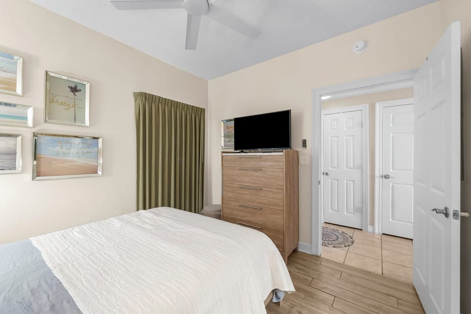 The second bedroom features a Queen-sized bed and its own television.