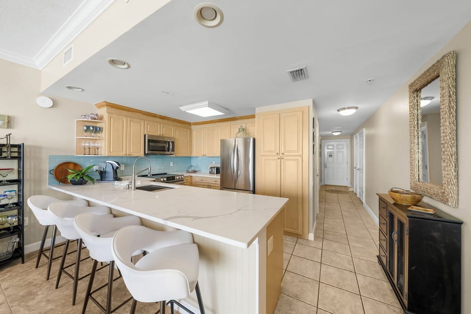The fully equipped kitchen features quartz countertops, stainless-steel appliances, and has everything you need to prepare meals for family & friends.