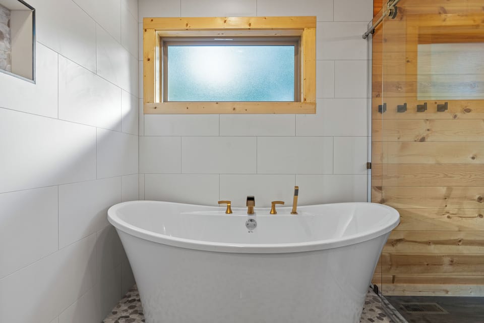 Spa-style bath with deep soaking tub & tile shower for two