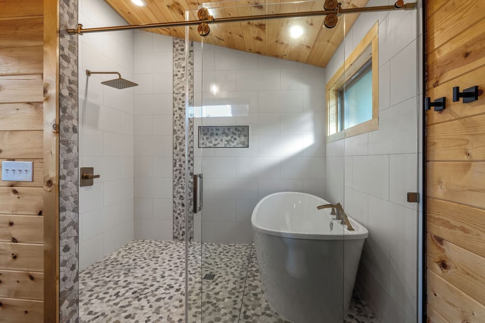 Spa-style bath with deep soaking tub & tile shower for two