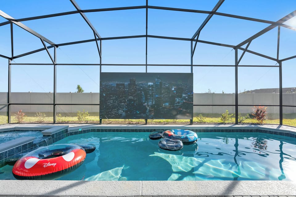 Discover your private oasis in this inviting pool area, complete with colorful floats and a relaxing spa. Enjoy the spacious layout filled with sunlight, perfect for unwinding and having fun in a serene environment.