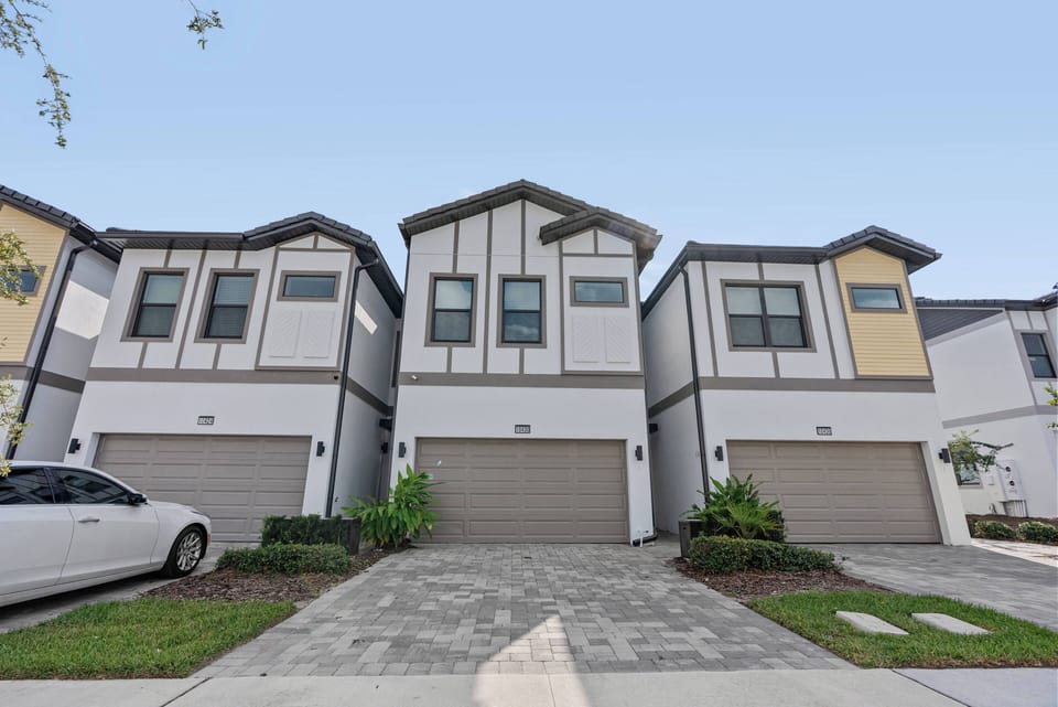 Experience the charm of this stylish home featuring unique architecture and clean lines. Its inviting façade, with crisp white and warm wood accents set amidst lush greenery, offers the perfect backdrop for your stay.