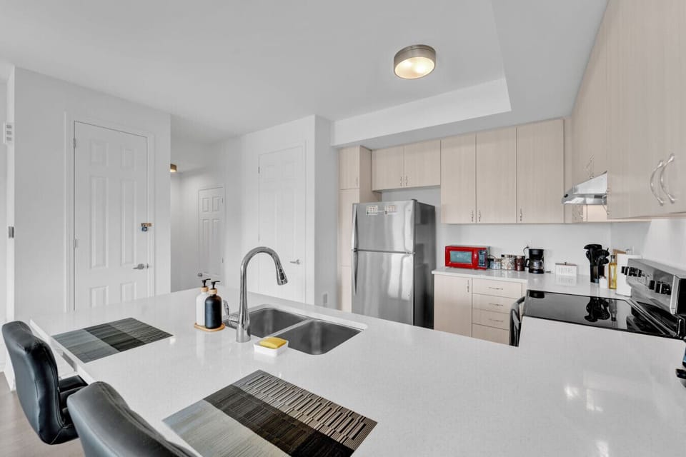 Prepare a home cooked meal with ease in this bright, modern kitchen. From the morning coffee station to the sleek breakfast bar, every detail is designed to make your culinary experience during your stay truly effortless.