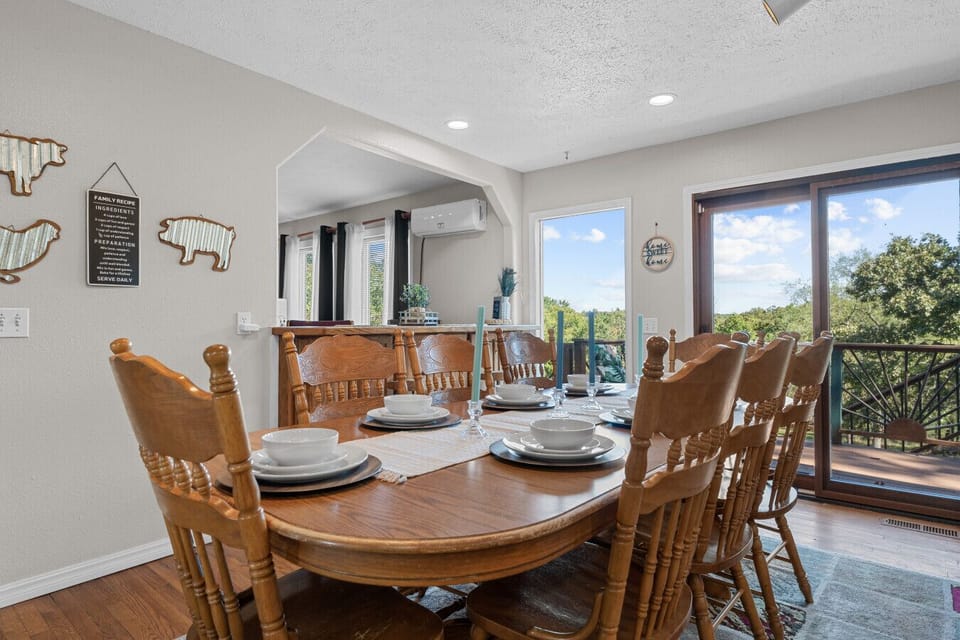 Dining Room | Bright Space with Sliding Deck Access, Wooden Table for Eight & Scenic Outdoor Views