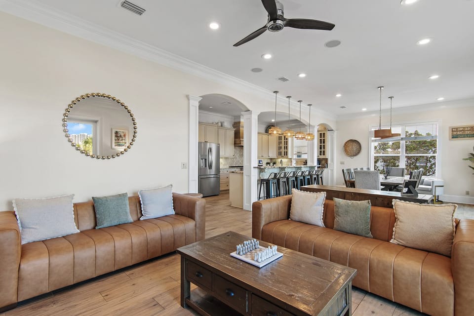 Coastal charm meets comfort! Spacious living area with smart TV & plenty of seating.