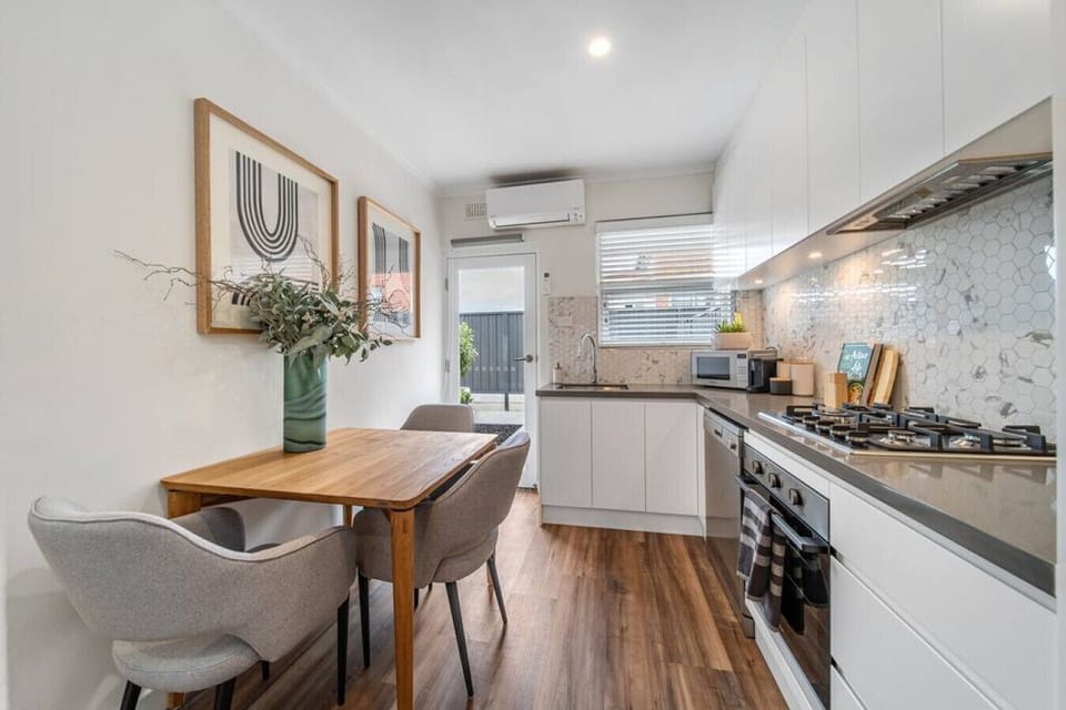 Share meals or morning coffee at the dining table, with the warm textures and timber floors adding a homely touch.