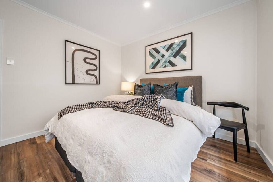 A serene retreat at day’s end—the primary bedroom blends comfort and simplicity for an easy sense of calm.