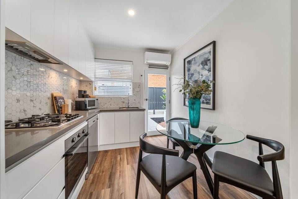 Gather around the dinning table for relaxed conversation and casual meals, framed by warm timber floors and a gentle, open feel.