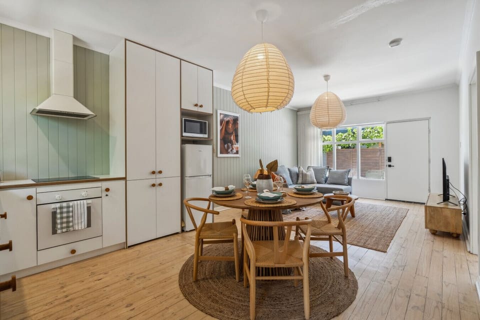 Gather around this beautifully set timber table for a home-cooked meal or a night of takeout in comfort.