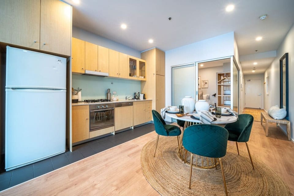 Velvet chairs and warm lighting invite a moment to slow down and enjoy meals at home.