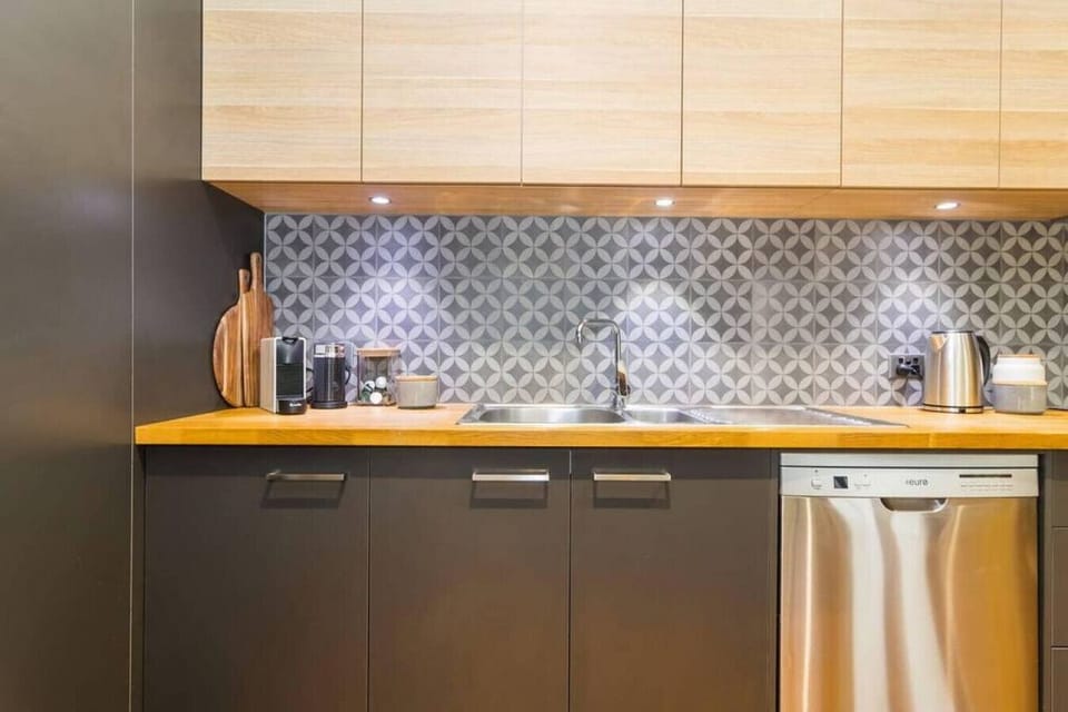 Small touches—like stacked boards and your morning essentials—make you feel right at home in the fully-equipped kitchen.