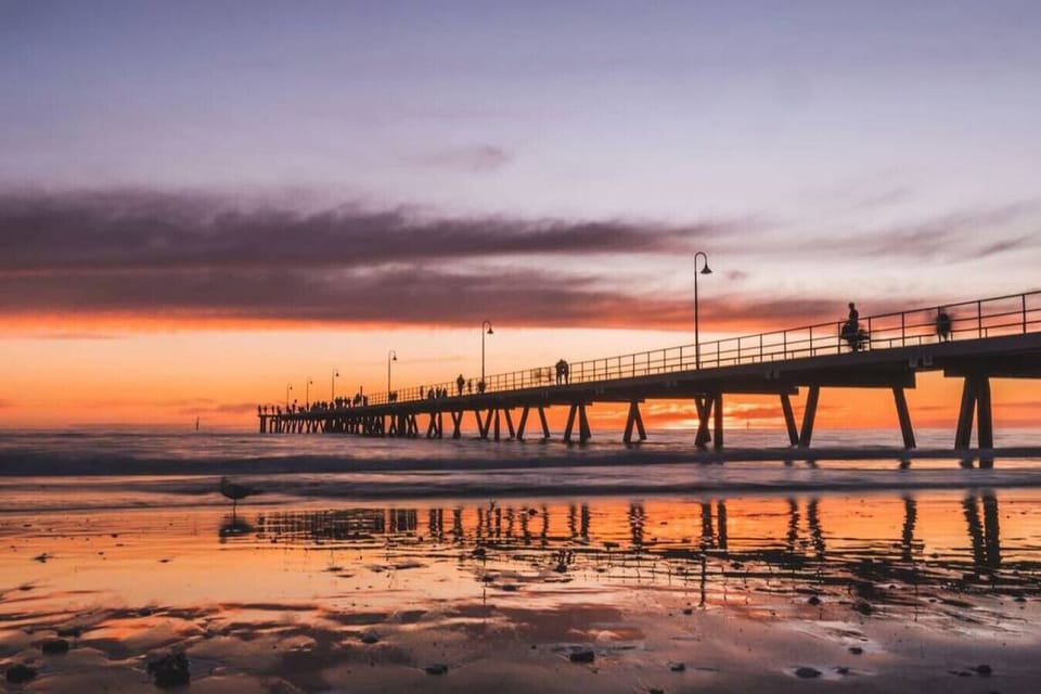 Watch the sky put on a show at sunset down at the Glenelg jetty.
