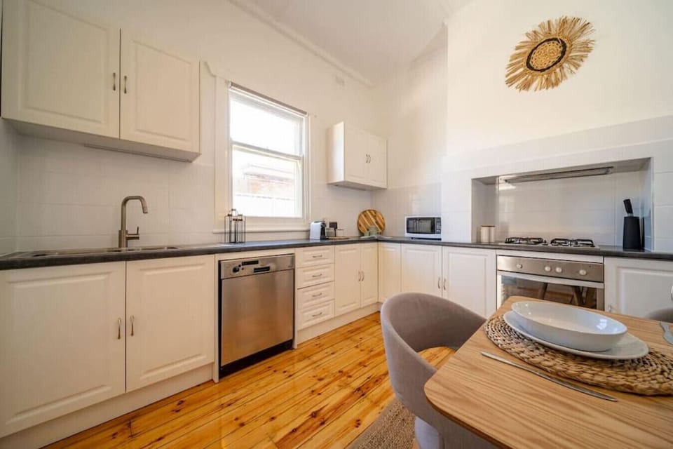 Clean lines and natural light highlight the well-equipped kitchen with modern stainless-steel finishes.
