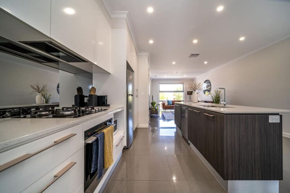 Cook with ease in the sleek kitchen, where generous bench space and modern finishes elevate everyday meals.