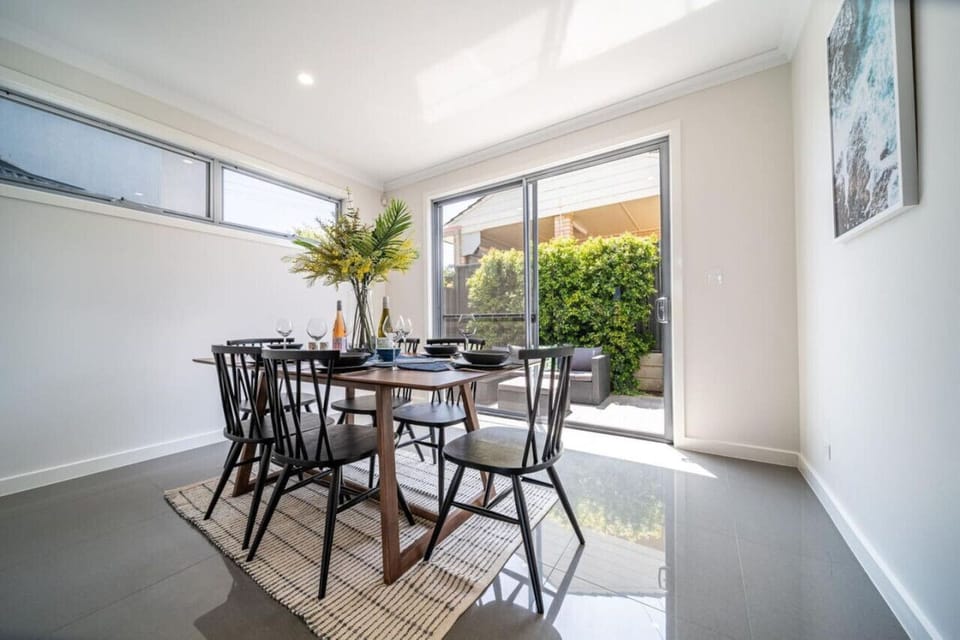 Gather around the dining table as natural light pours in, setting the scene for shared meals and easy conversation.