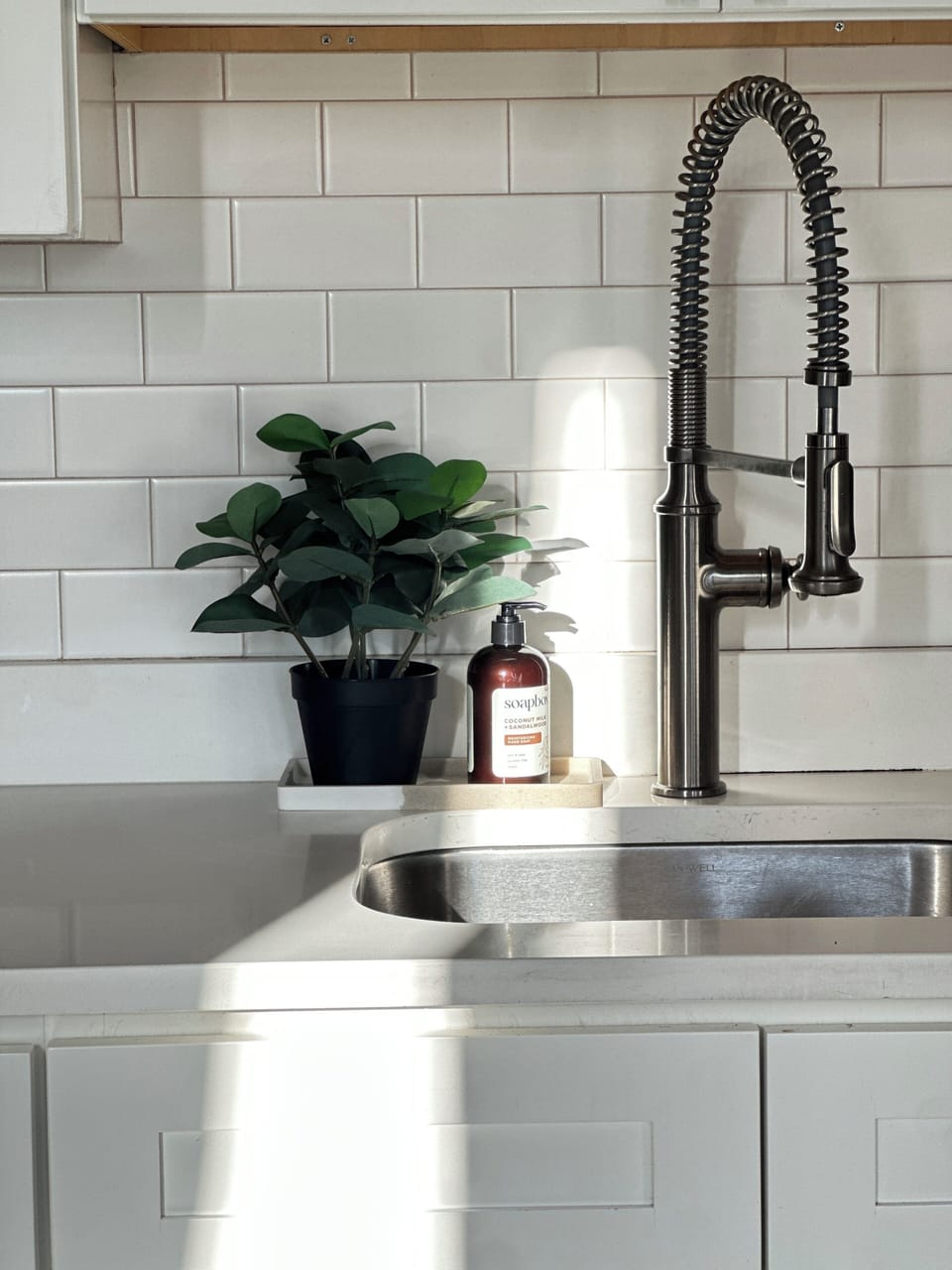 A sleek stainless-steel sink with a modern faucet adds a refined touch.