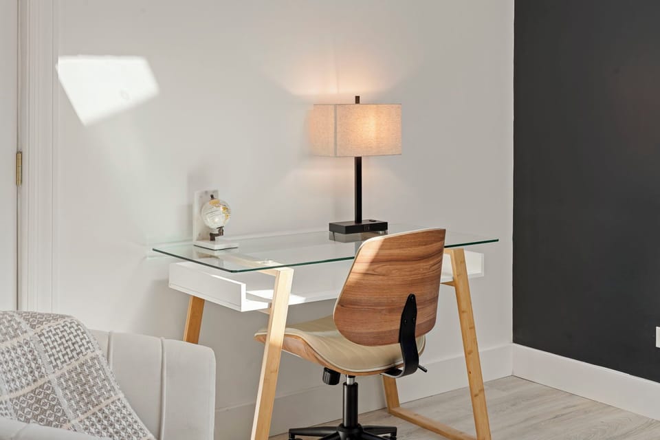 a designated workspace with glass table and side light