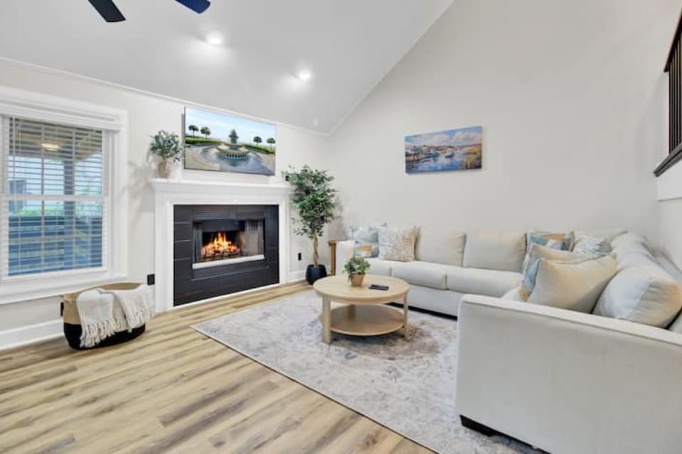 Open living with fireplace, cozy seating and a dining space to gather.