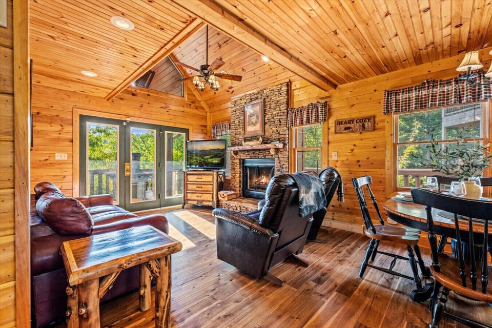 Gather everyone in the heart of the cabin with soaring wood ceilings, a cozy stone fireplace, and space to relax together. Whether it’s movie night or quiet conversation, this room invites you to stay awhile.