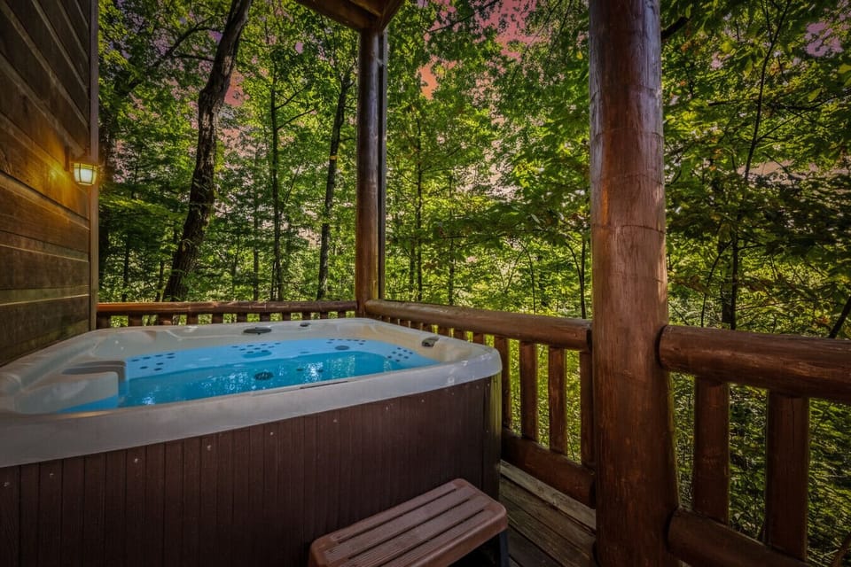 As evening falls, the hot tub becomes a peaceful escape—warm water, glowing sky, and the forest settling in for the night.