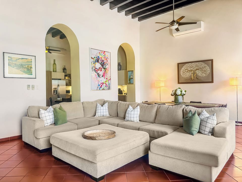 Alternate living room angle with dramatic arches & oversized seating.
