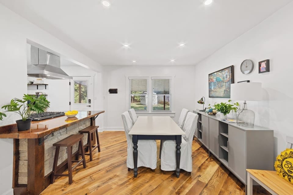 Dining table sits 6.  Back door opens onto the covered back porch with outdoor furniture with seating for 4.