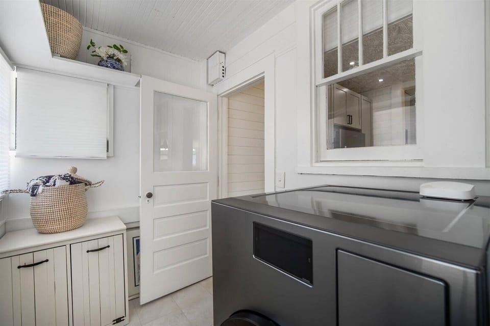 Laundry with detergent pods & dryer sheets, beach towels, and backyard access.
