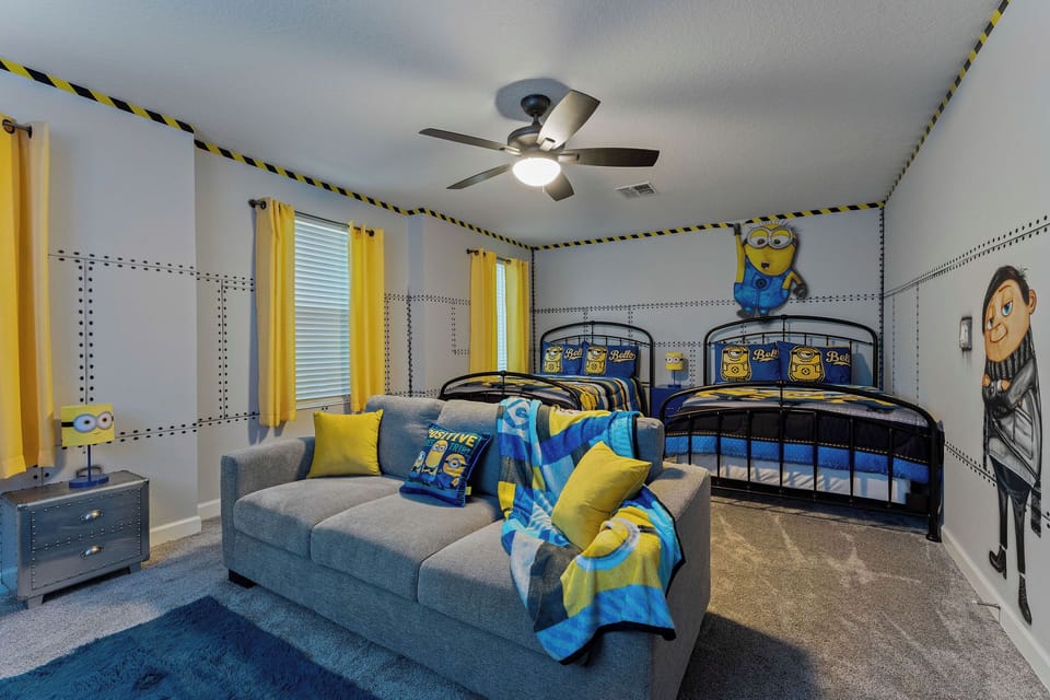 Minion theme room on 2nd floor with 2 full beds, seating, and Xbox.