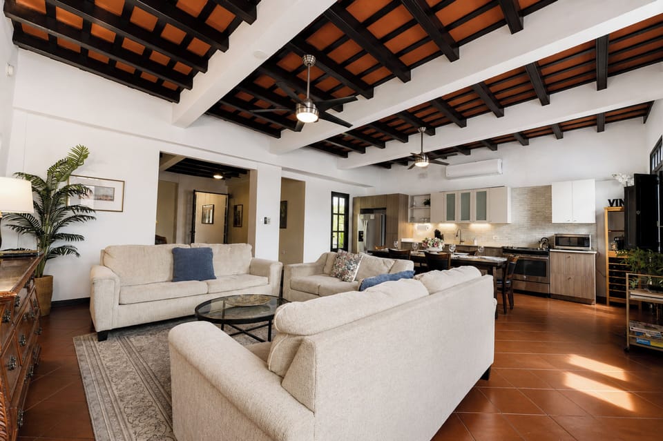 Spacious open living room with comfortable seating & large Smart TV.