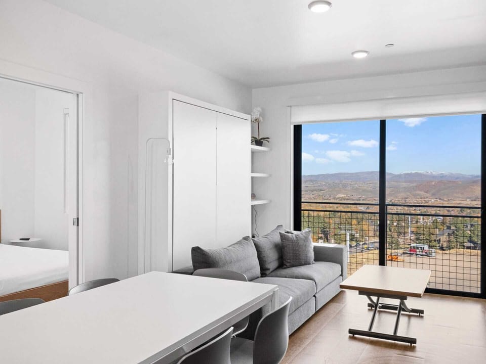 Dining, living, floor-to-ceiling windows, and the queen room off to the side.