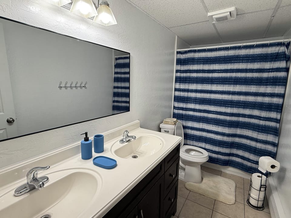 The two-sink bathroom is stocked with starter necessities. 