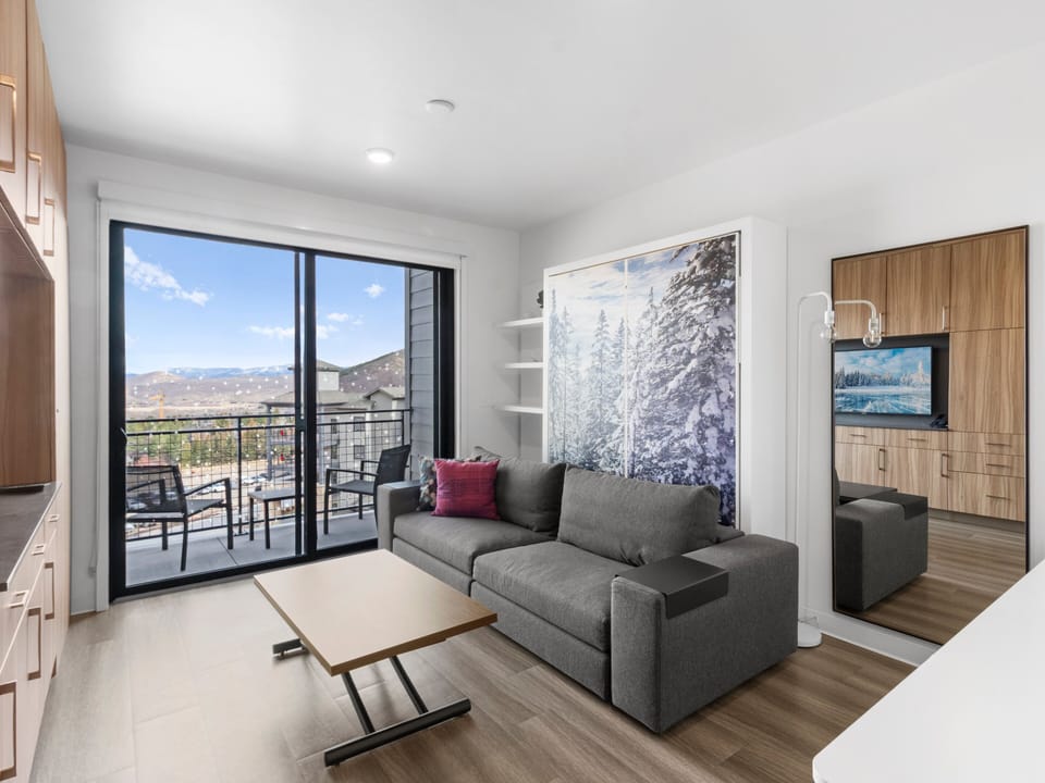 Studio living area with queen Murphy bed and balcony