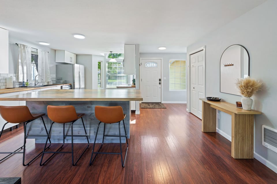 The kitchen features a 3 seat island bar