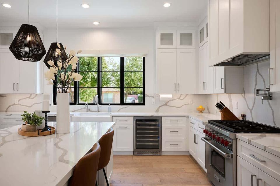 Fully equipped kitchen with stainless steal appliances, mini fridge, and a kitchen island with bar seating for 5 guests.
