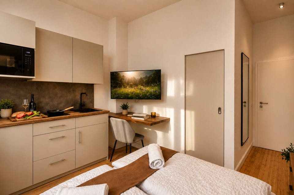 Enjoy the convenience of a thoughtfully designed studio with a functional kitchenette, comfortable bed, workspace, and modern amenities that make you feel right at home.