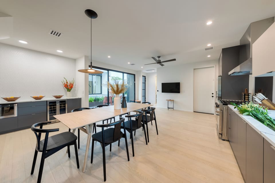 Bright and spacious open-concept with dining space, kitchen, and a wine cooler. (Primary home)