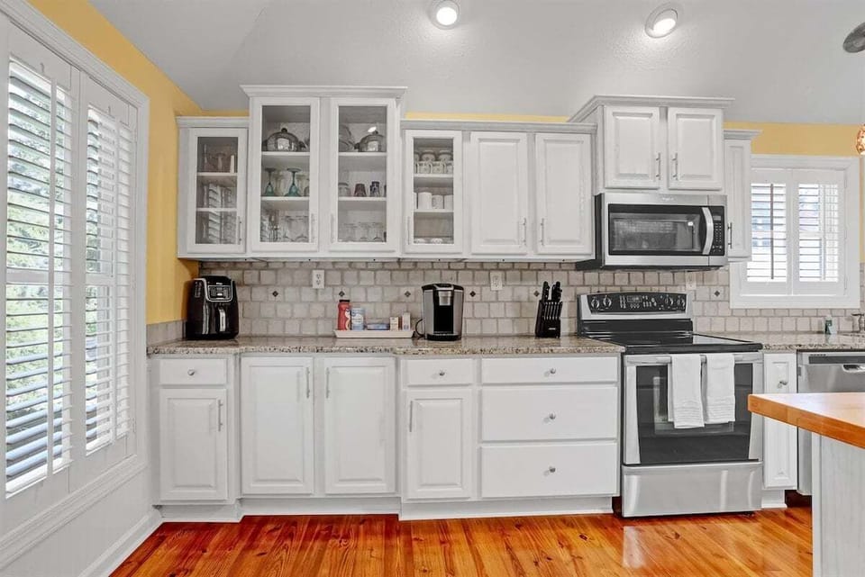 Fully stocked kitchen with modern appliances, granite countertops, and a convenient coffee bar to start your mornings right.