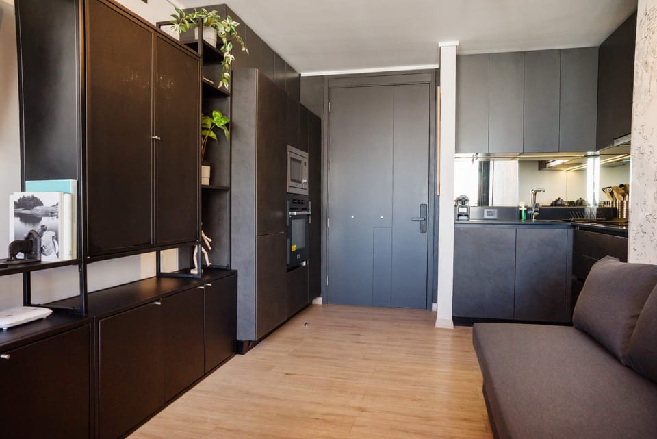Sleek and modern kitchen with built-in appliances and minimalist design, perfect for a cozy stay.
