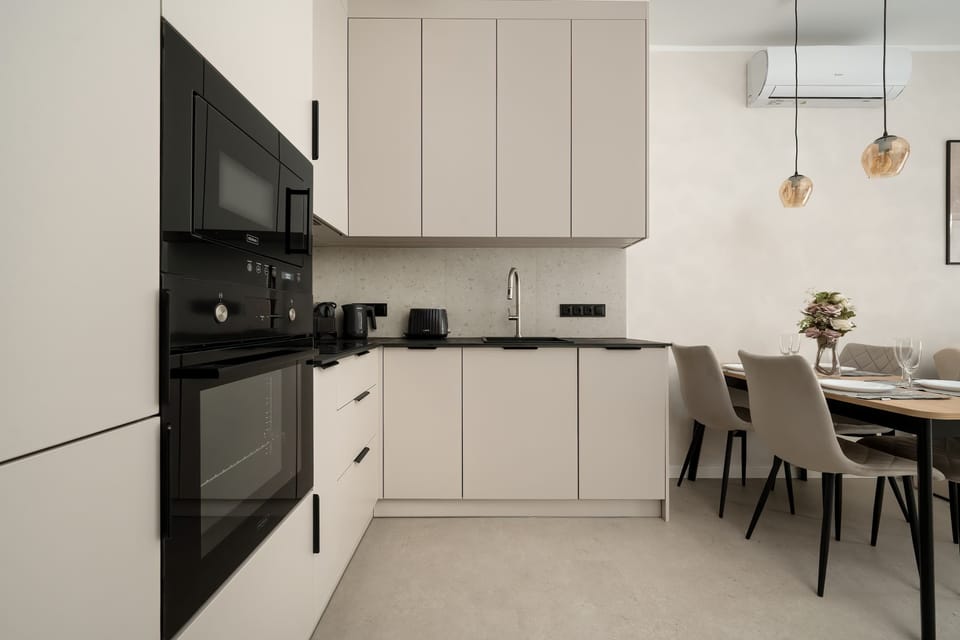 The sleek design of the kitchenette blending seamlessly with the living area.