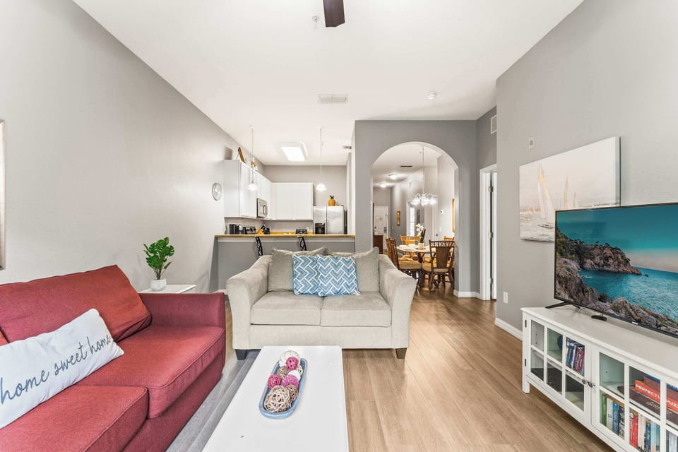 Bright living area with Smart TV, balcony, and sofa sleeper