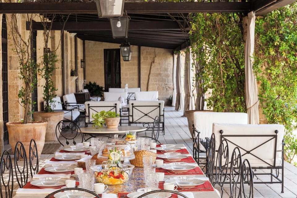 The al fresco dining area in the loggia looking out into the courtyard garden.